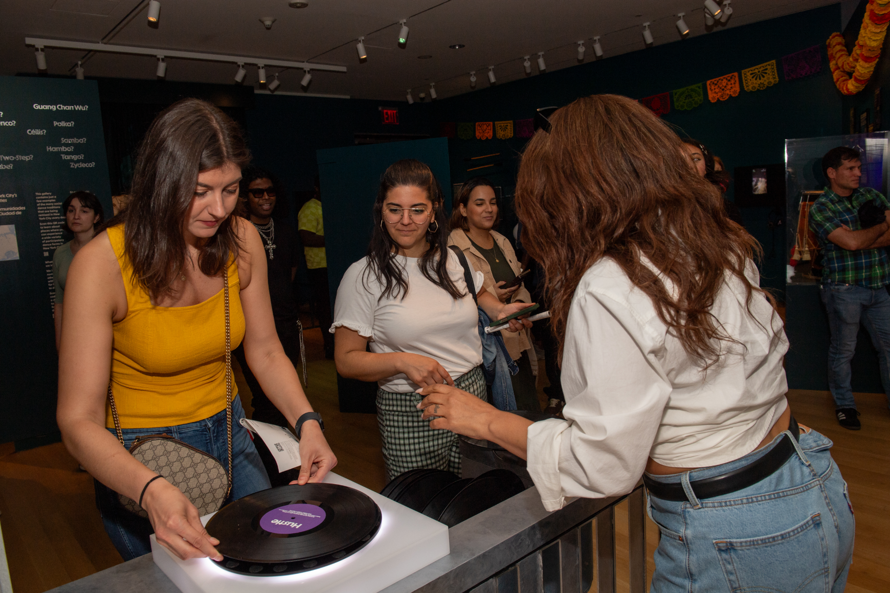 Women spinning a record on a DJ table